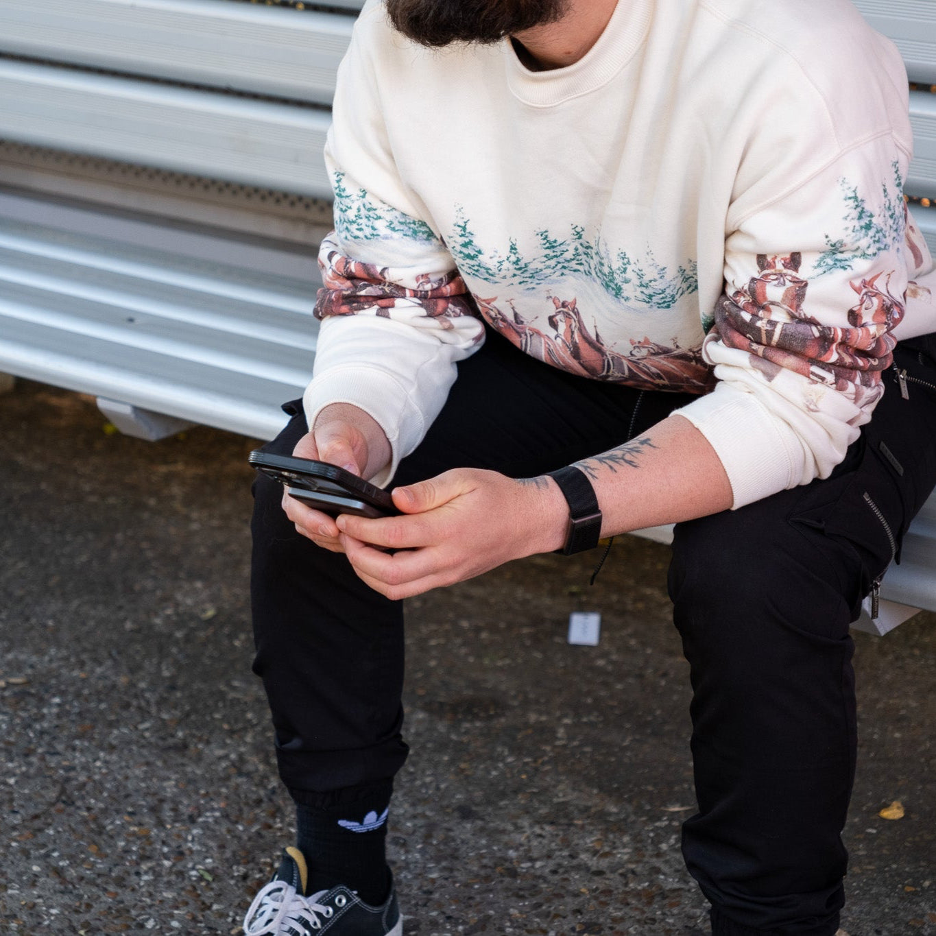 Ultra slim power bank in a persons hand on a bench